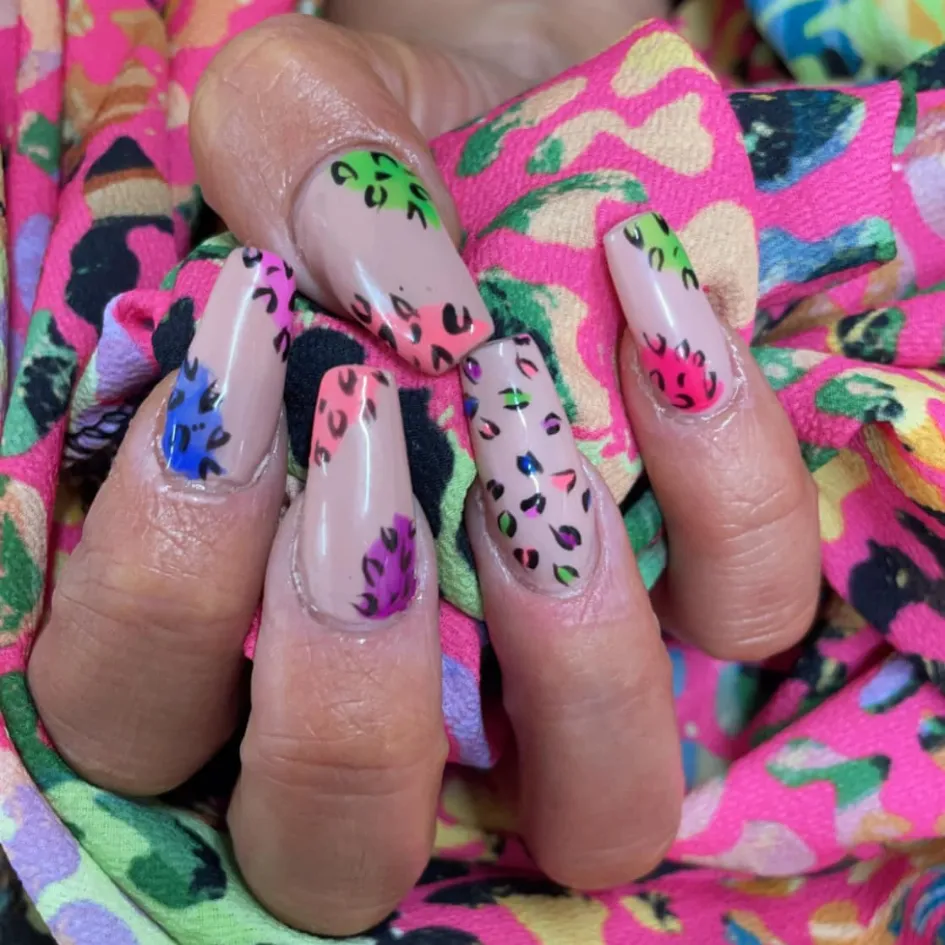 Brightly colored animal print nail art at Sweet Chanice Beauty Salon.
