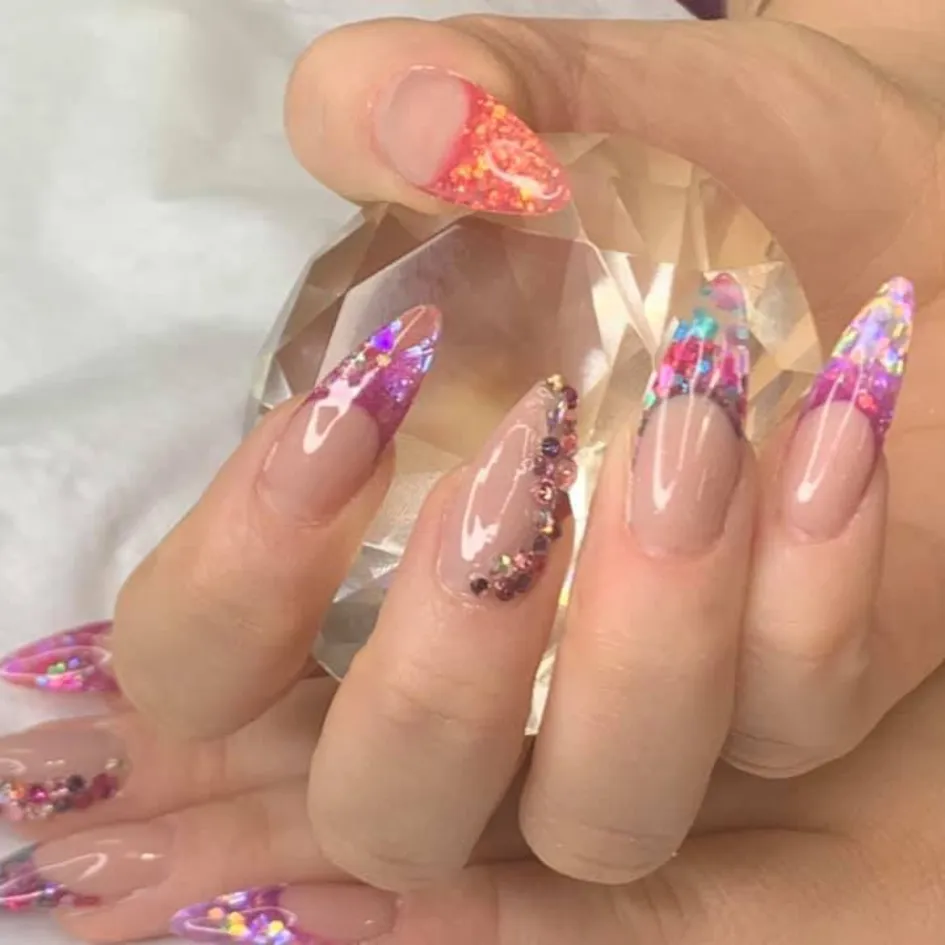 Glittery ombre nails with gemstone accents at Sweet Chanice Beauty Salon.