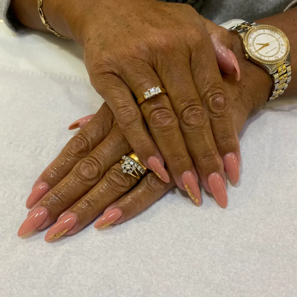 Elegant nude and gold nail art at Sweet Chanice Beauty Salon.