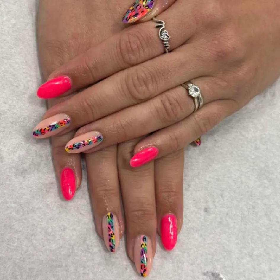 Pink nails with colourful leopard print details at Sweet Chanice Beauty Salon.