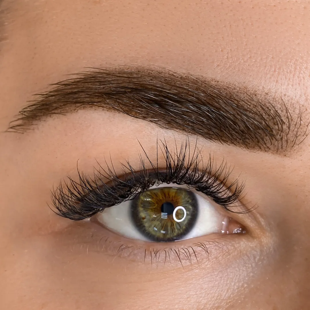 Hazel eye with expertly laminated eyebrows, showcasing a defined and polished look by Sweet Chanice.